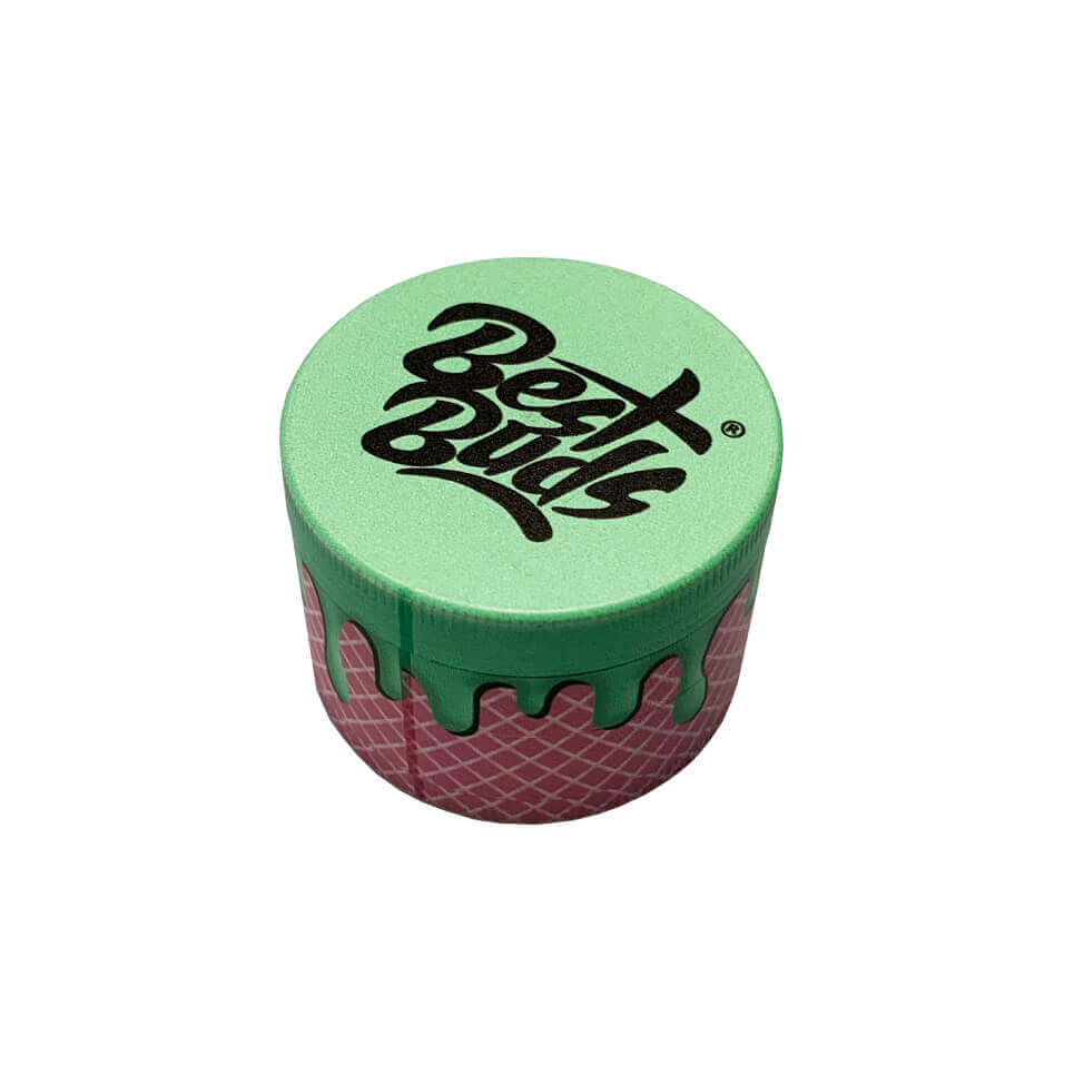 Best Buds 4-part metal grinder in green and pink design for efficient herb grinding with stylish branding.